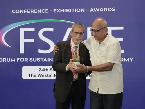 Siraj Hussain being presented a plant as a memento at the Forum for Sustainable Food Economy in Mumbai